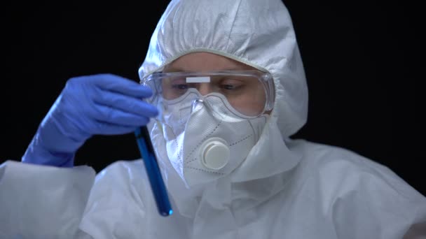 Worker of scientific lab holding test tube with biological hazard sign, harm - Filmagem, Vídeo