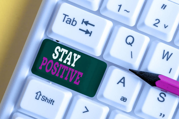 Writing note showing Stay Positive. Business photo showcasing Engage in Uplifting Thoughts Be Optimistic and Real White pc keyboard with note paper above the white background. - Photo, Image