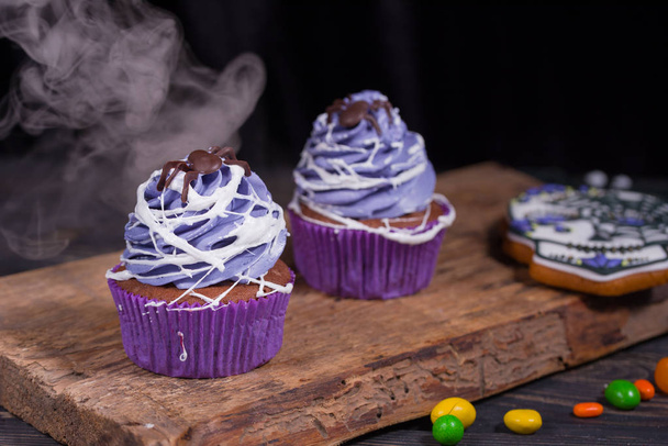 Halloween party and decoration conceptt. Halloween cupcakes and colored sweets - Photo, Image