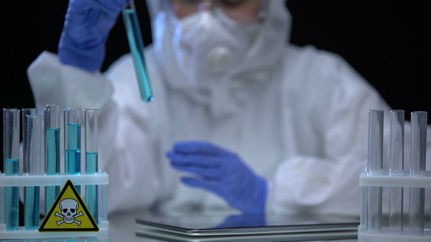 Lab worker inspecting test tubes with poison for sediments, dissolution process - Footage, Video