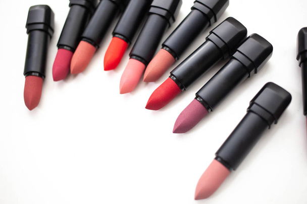 lipstick in different natural colors on a white background. Top view - Photo, Image