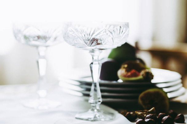 beautiful crystal champagne glasses with figs and nuts on table - Zdjęcie, obraz