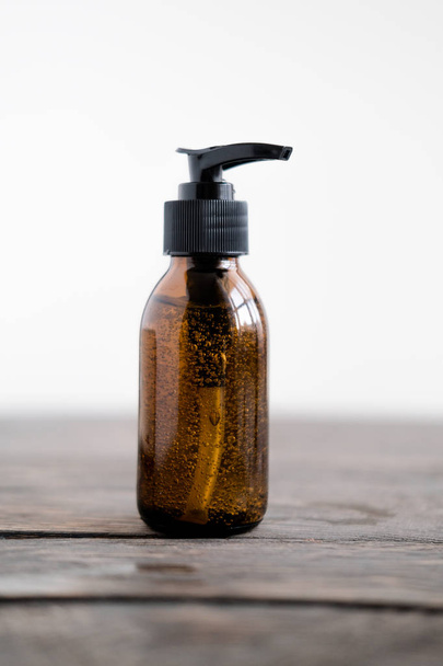 Cosmitics dark amber bottle with pump  - Фото, изображение