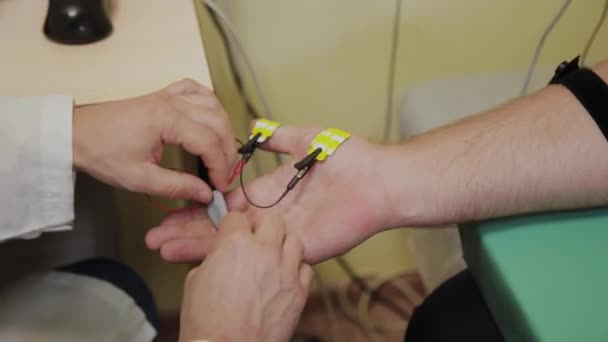 Mannelijke arts onderzoekt een patiënt met een medisch hulpmiddel. - Video