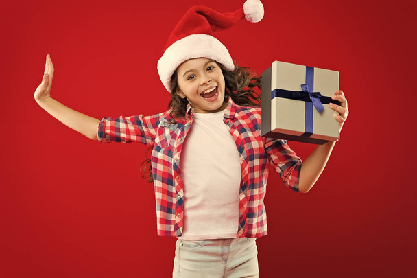Christmas shopping. Little girl child in santa hat. Present for Xmas. Childhood. New year party. Santa claus kid. Happy winter holidays. Small girl. Love is in the air. happiness. - 写真・画像