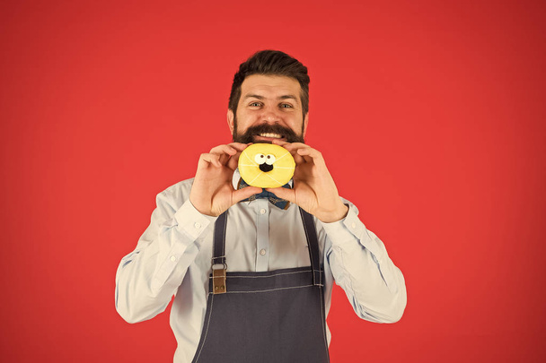 baker hold donut. Funny hipster. Sweet donut. Chef man in cafe. Diet and healthy food. Doughnut diet. Calorie. Feel hunger. Perfect donut. Bearded man in apron. Donut food. Adding some fun to his day - Photo, image