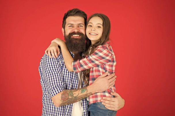 Celebrate fathers day. Family values concept. Family bonds. Friendly relations. Father hipster and his daughter. Happy moment. Man bearded father and cute little girl daughter on red background - Zdjęcie, obraz