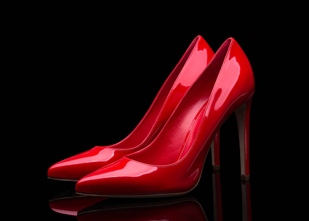 Red high heeled shoes and black background - Foto, afbeelding