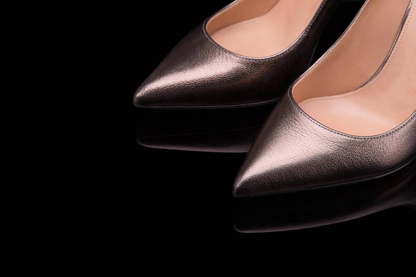 Classic shoes of bronze color on a black background - Photo, image