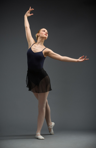Full-length portrait of dancing ballerina with outstretched arms - Fotó, kép