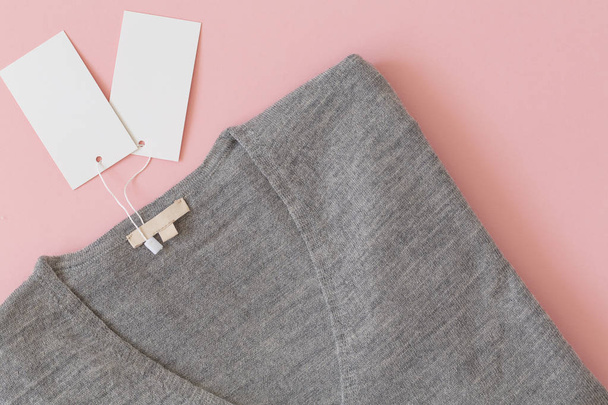 Female gray  jumper on pink background. Fashion clothes set trendy cozy jumper. Female fashion look. Flat lay composition. Copy Space. - Foto, Bild