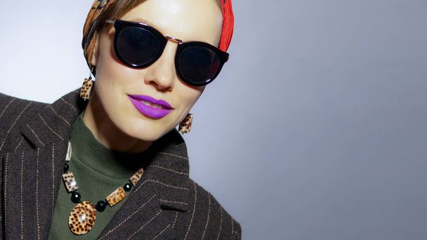 Stylish autumn woman wearing headscarf, sunglasses, bright makeup, accessories, fashion - Fotó, kép