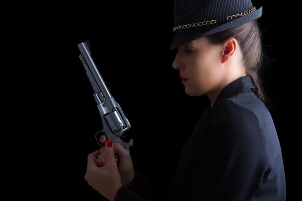 Dangerous woman in black with silver handgun - Фото, изображение