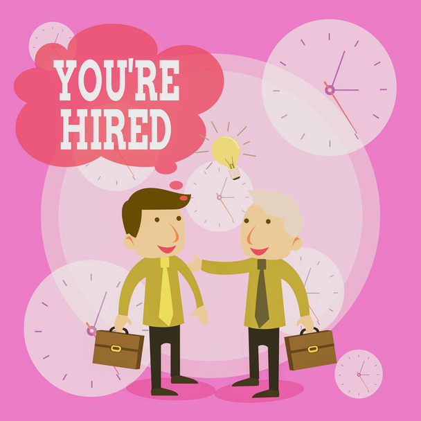 Conceptual hand writing showing You Re Hired. Business photo text New Job Employed Newbie Enlisted Accepted Recruited Businessmen Colleagues with Brief Case Sharing Idea Solution. - Photo, Image