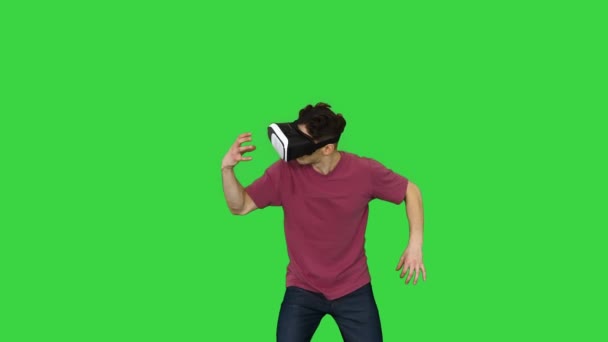 Amazed man using VR headset glasses touching and interacting with virtual reality world on a Green Screen, Chroma Key. - Video