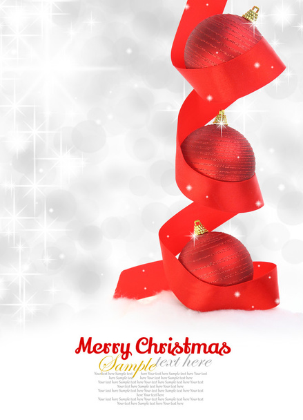 Red Christmas balls with ribbon on snowy background - Photo, Image