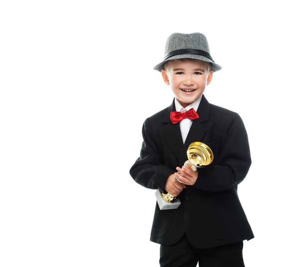 Boy holding prize cup - Φωτογραφία, εικόνα