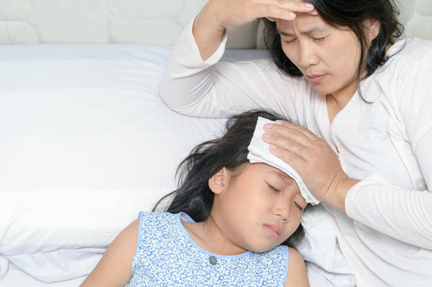 Mom suffering from migraine because her daughter sick  - Photo, Image