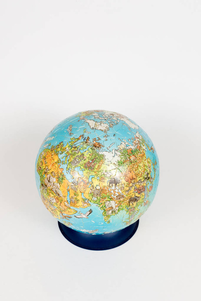 full-color globe on a stand on a white background. selective focus - Fotografie, Obrázek