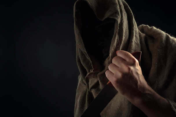 Hooded man with  big knife. - Photo, Image