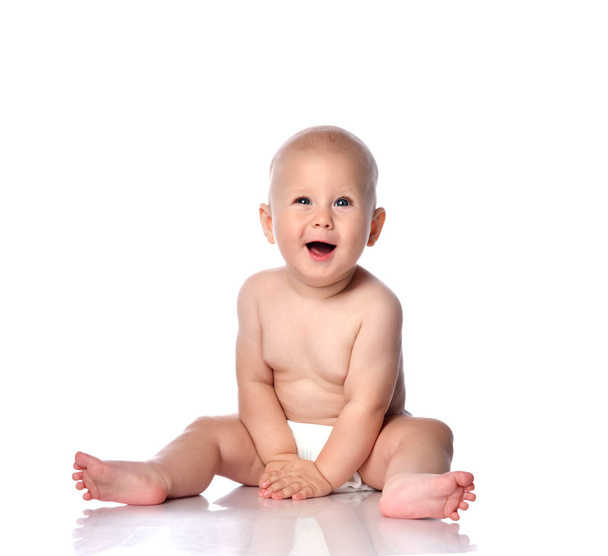 Infant child baby boy toddler sitting in diaper happy smiling laughing playing isolated on a white - Fotoğraf, Görsel
