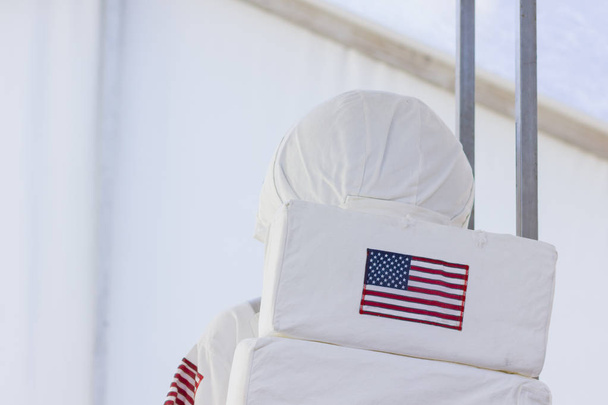 USA flag on an astronaut spacesuit. Astronaut USA, view from the back. National flag of the USA on a white astronaut spaceman backpack - Photo, image