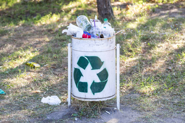 Przepełnione kosze na śmieci w parku. Dumpster jest pełen śmieci - Zdjęcie, obraz