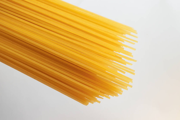 Italian uncooked spaghetti isolated on white background, top vie - Фото, зображення