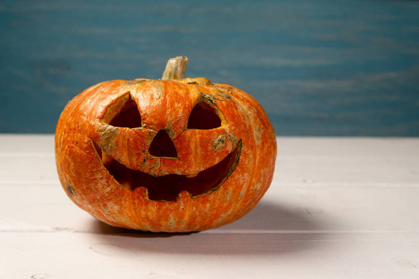 Halloween pumpkin on a wooden table on a background of white boards. Halloween background. - Photo, Image