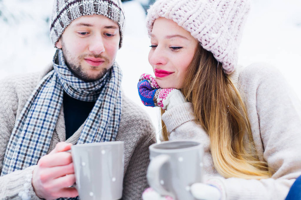 close-up couple in love in warm clothes sit with each other and  - Photo, Image