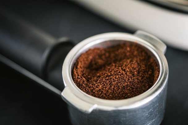 Ground black coffee in portafilter - Фото, изображение