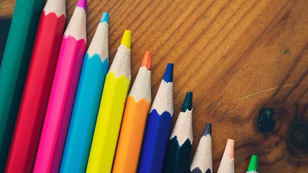 Color Pencils on a wooden table. - Fotó, kép