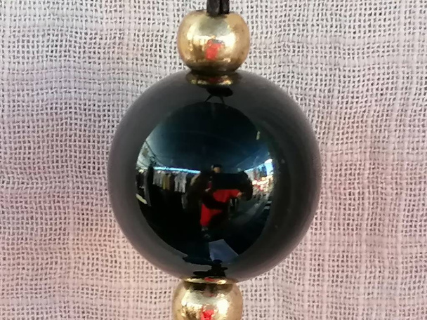 Close-up of black ball necklace. - Photo, Image