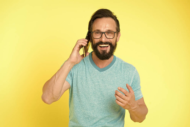 brutal caucasian hipster with moustache. happy conversation. Business. Bearded man speaking on phone. modern life with digital technology. Mature hipster with beard. Confident and handsome Brutal man - Фото, зображення