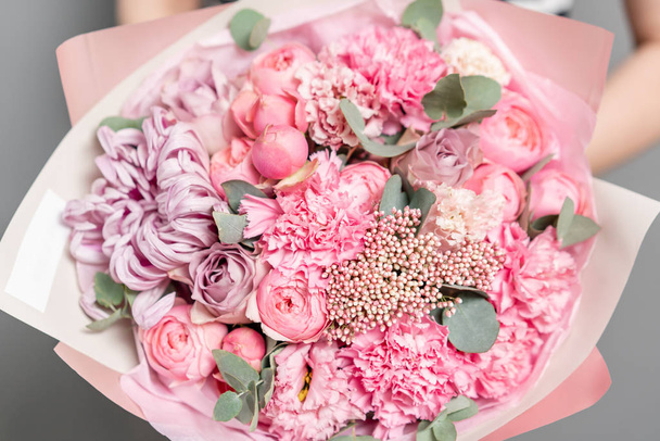 Closeup mixed flowers in bouquet. the work of the florist at a flower shop. Delicate Pastel color. Fresh cut flower. Pink color - Fotó, kép