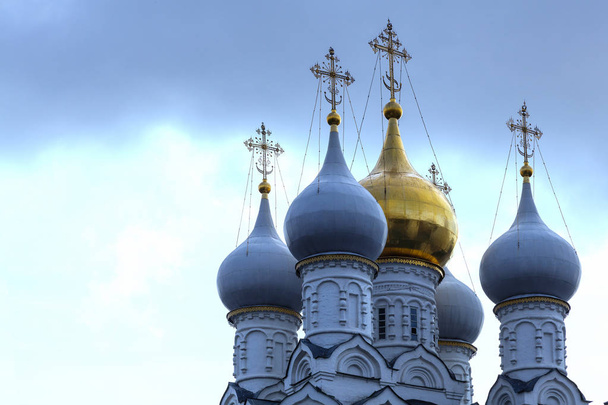 Multi-colored domes of the Orthodox Church on a background of rainy sky - Фото, изображение