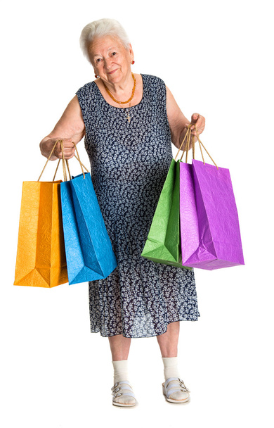 Happy old woman with shopping bags - Фото, изображение