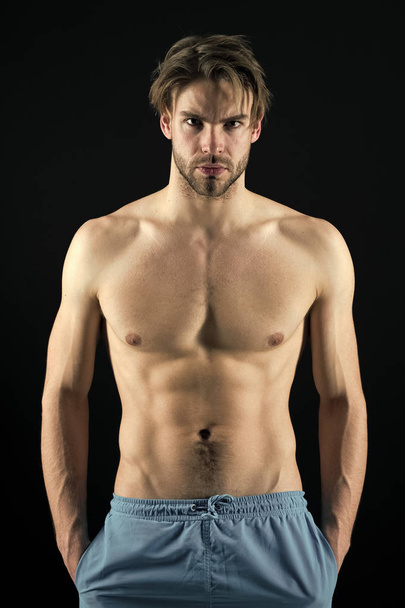 Sportsman with six pack and ab muscles. Macho with sexy torso and chest. Man bodybuilder with fit body. Training and workout activity in gym. Sport or fitness and bodycare concept - Foto, afbeelding