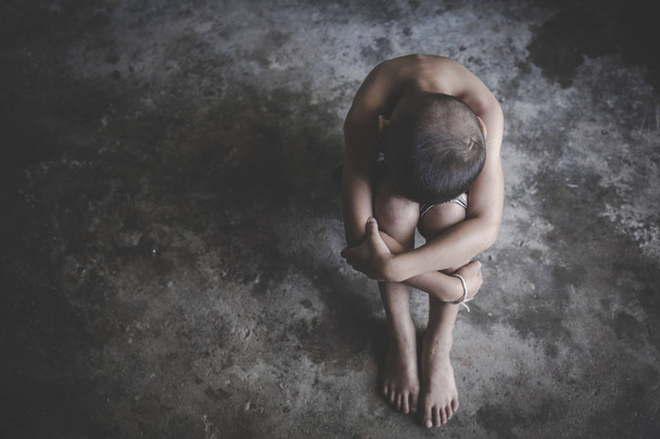 La fille était assise déprimée dans une pièce sombre, Violence contre les enfants
 - Photo, image