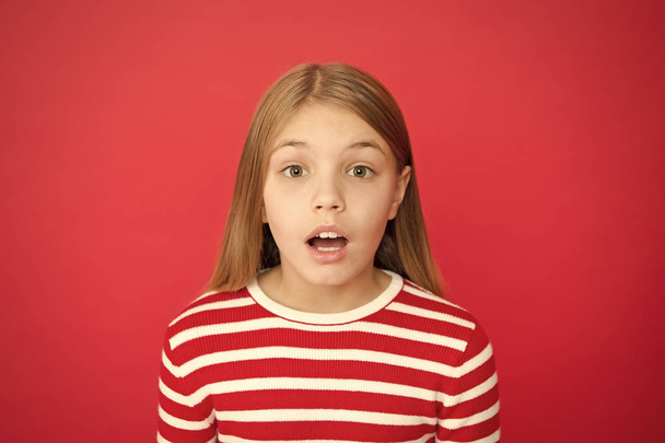 Childhood happiness. small girl child. School education. family and love. childrens day. Good parenting. Child care. surprised little girl on red background. Oops - 写真・画像