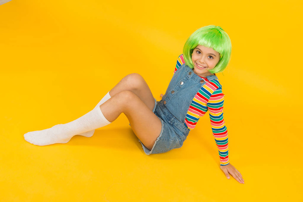 Semi permanent color cream. Colored clip in hair extensions. Change color. Pigment dye hair. Freedom for expression. Fantasy hair trend. Kid girl with bright vibrant hairstyle. Artificial wig concept - Valokuva, kuva
