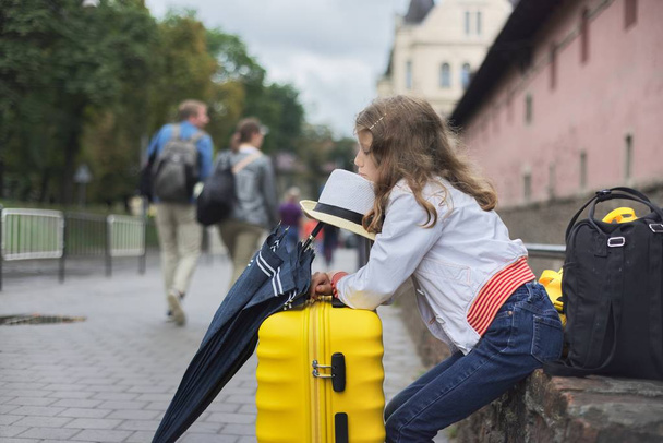 Concept of tourism, travel, little girl with luggage - Fotó, kép