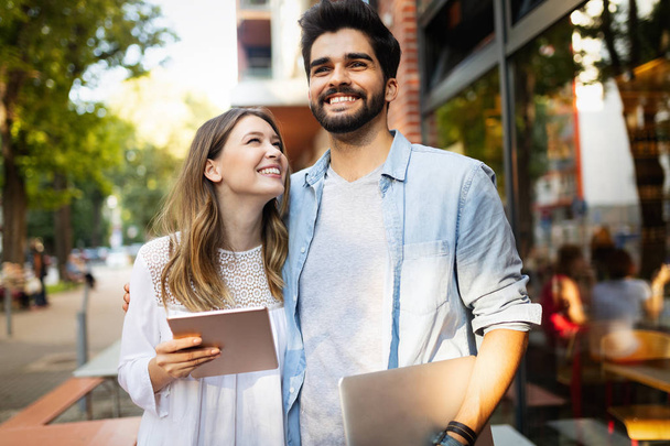 Cheerful young couple using digital tablet outdoors - Photo, Image