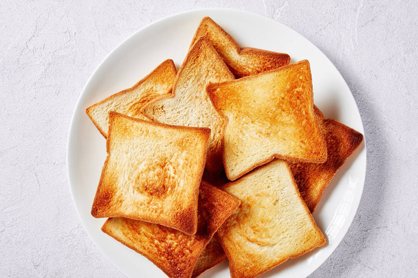 close-up of  browned toasts on a plate - Fotó, kép