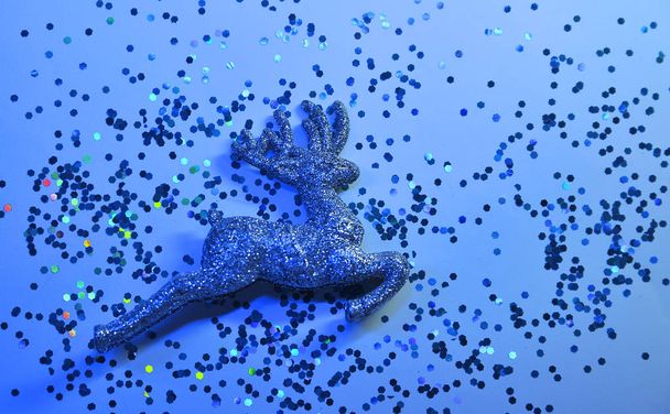 Christmas deer on sparkling glitters. Festive background. - Photo, Image