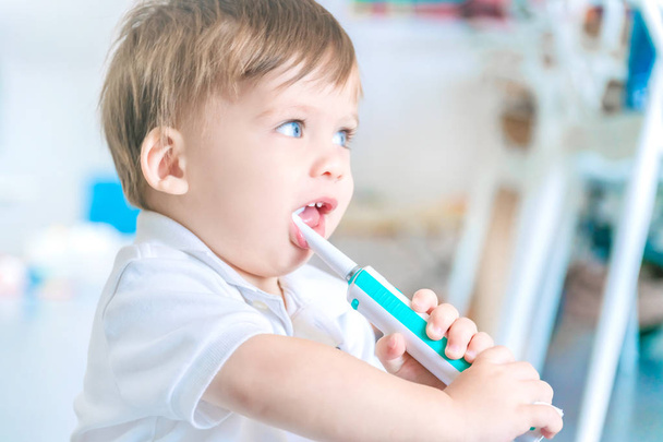 Cute little boy brushing his teeth. - Фото, зображення