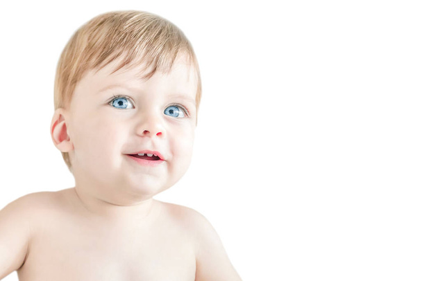 Happy blonde  blue-eyed baby on a white background. Isolated. - Photo, image