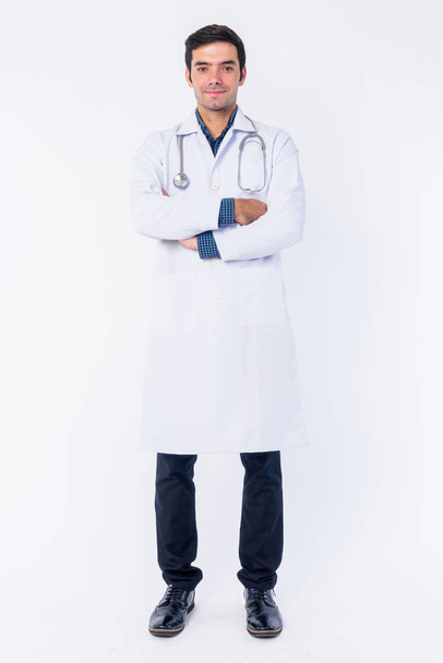 Full body shot of young Persian man doctor with arms crossed - Fotografie, Obrázek
