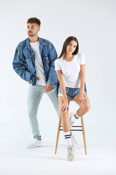 Fashionable young couple on white background - Fotoğraf, Görsel