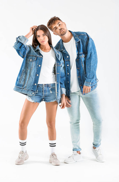 Fashionable young couple on white background - Foto, Imagen